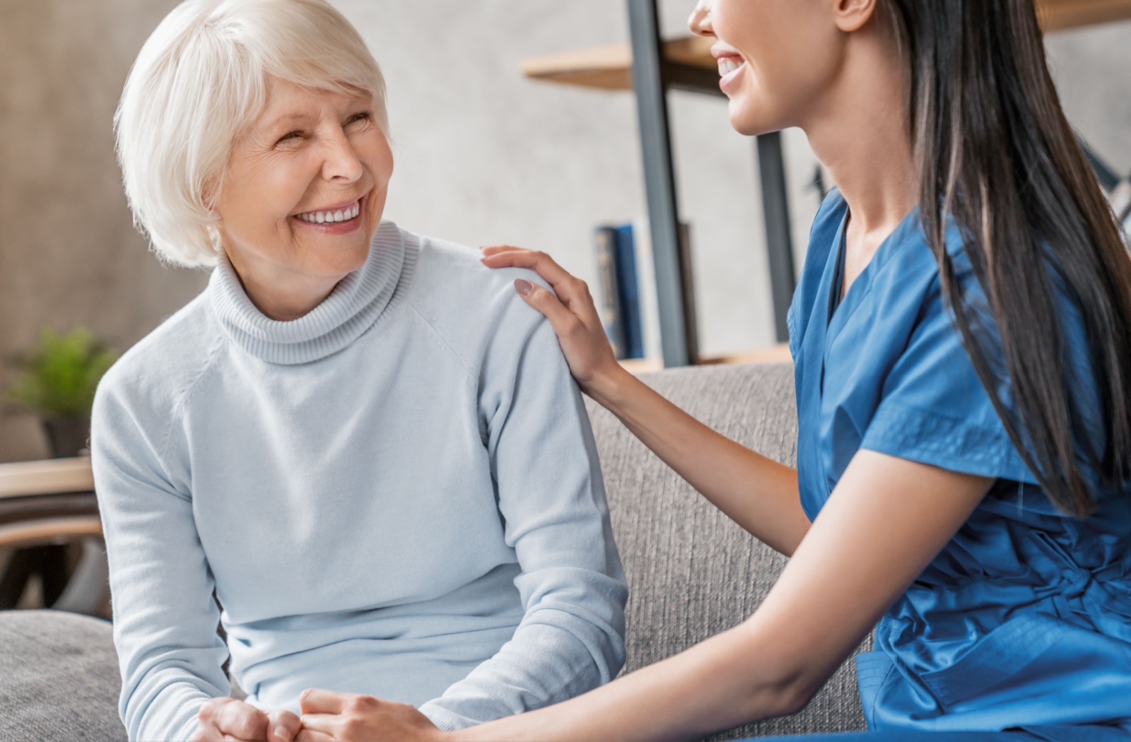 A senior woman chats with her caregiver