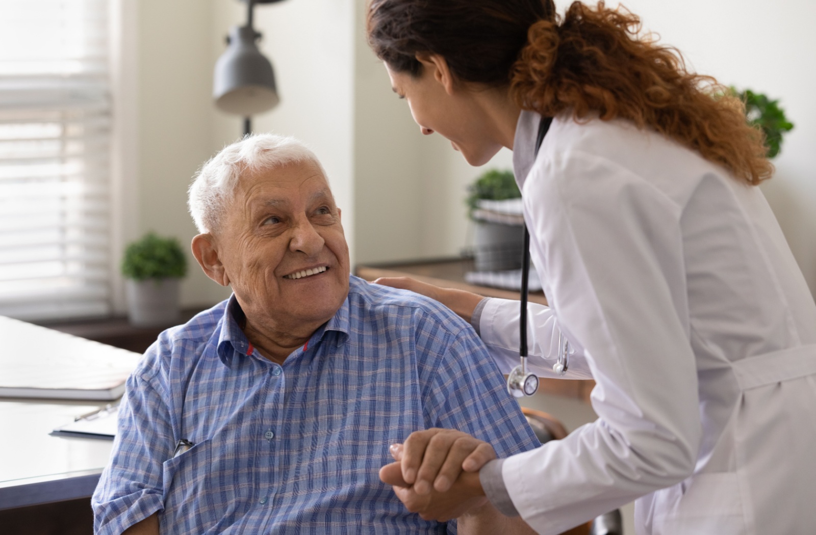 On-site nurse and resident smiling during check-up.