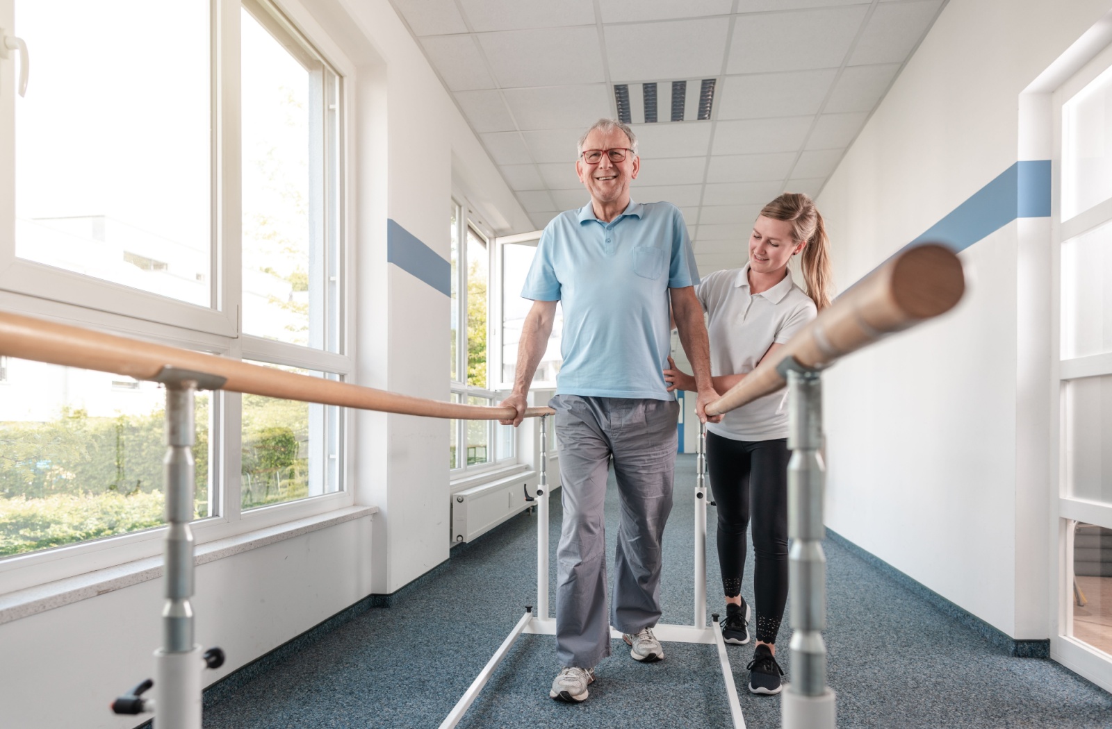 A resident working with their physical therapist while in rehabilitation for recovery.