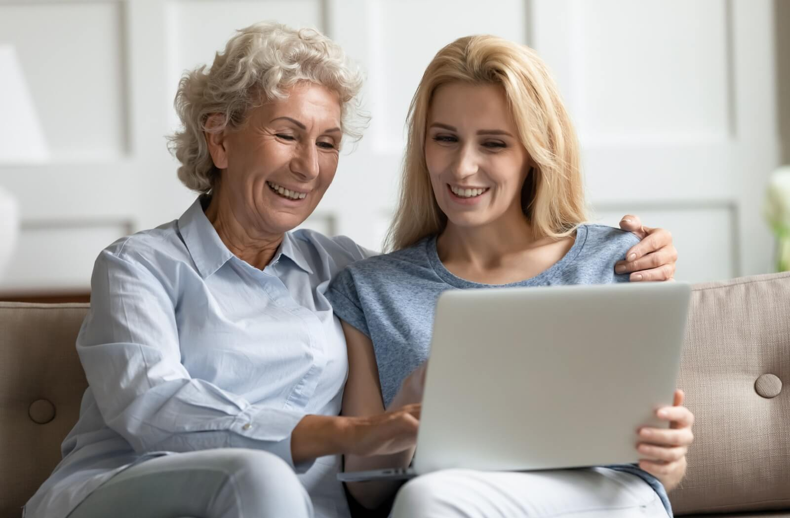 An adult uses their laptop to show their older parent memory care communities in their community to get their thoughts