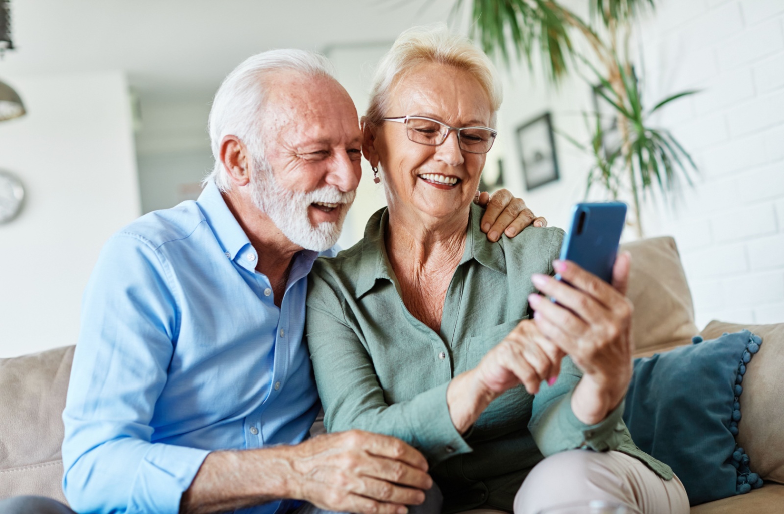 A senior couple video call with their family from a cellphone.